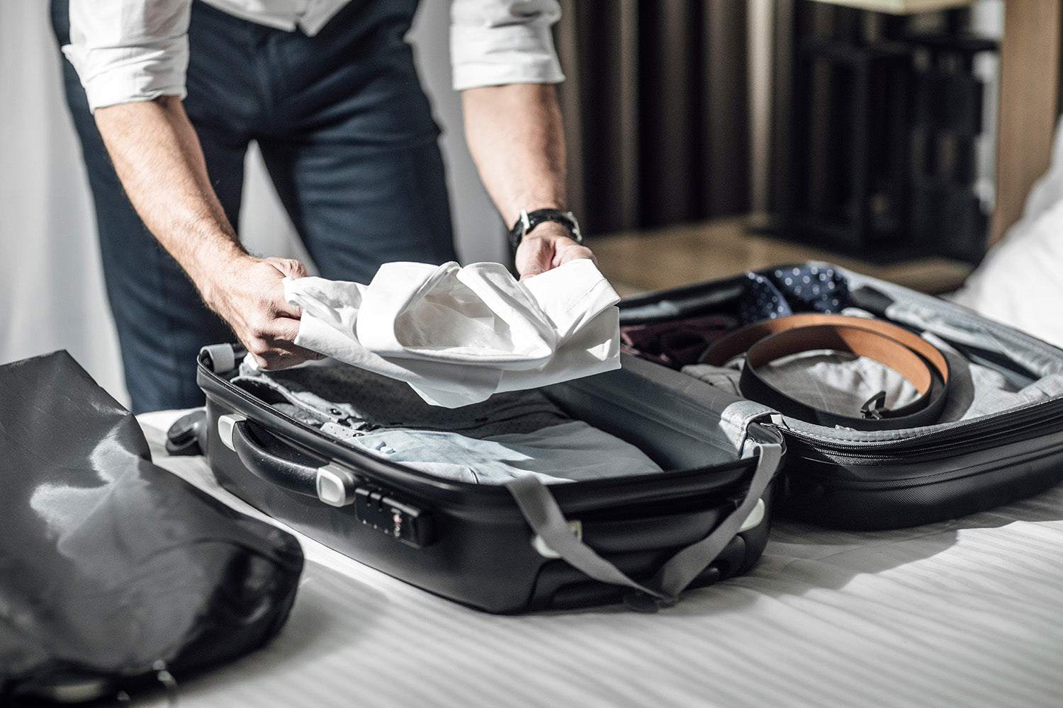 Businessman packing things for business trip
