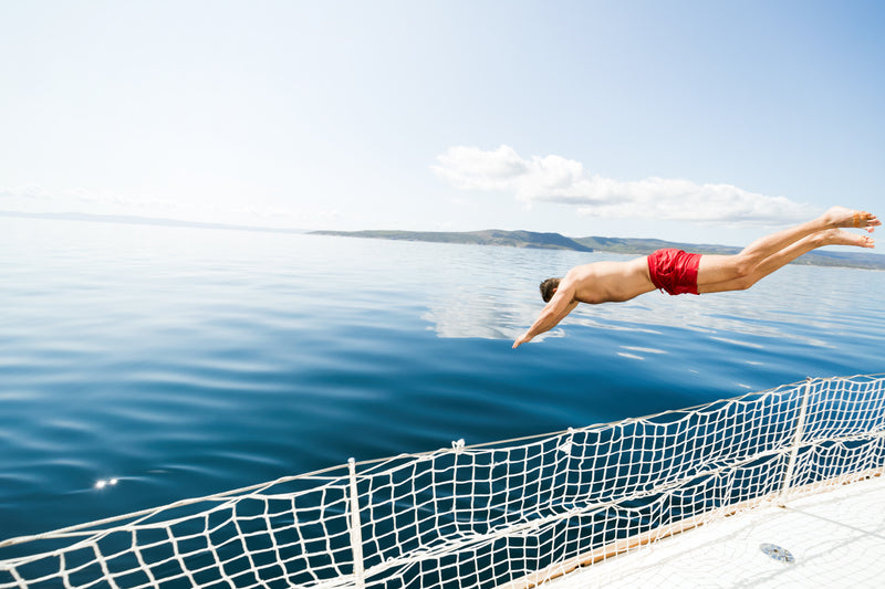 man, swim trunks, water, boat 